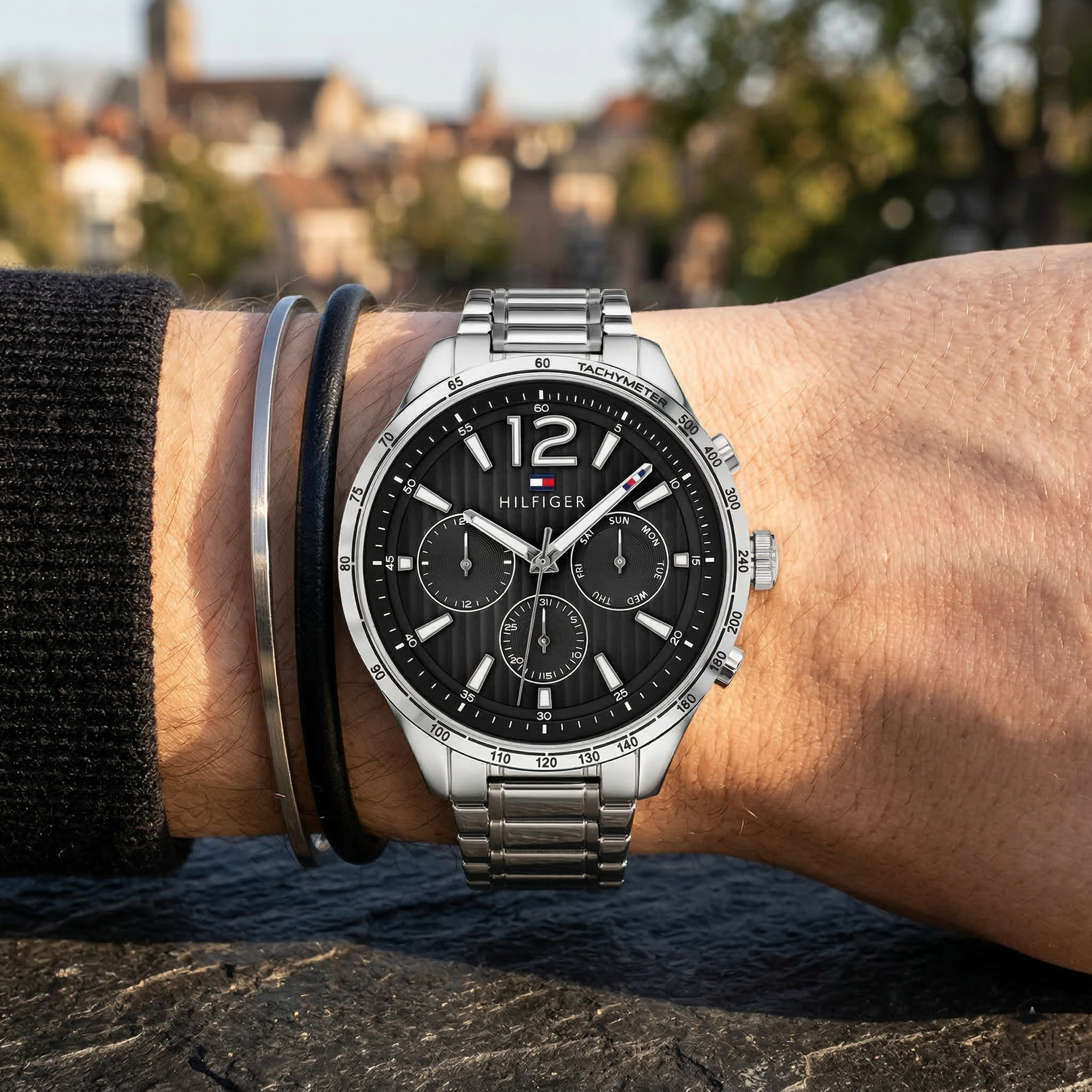 Close up of Tommy Hilfiger Gavin 1791469 men's quartz battery watch on wrist showing black textured dial and silver stainless steel bracelet