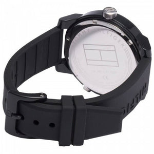 Caseback of Tommy Hilfiger Denim 1791555 men's quartz battery watch showing technical specs black dial and rubber strap