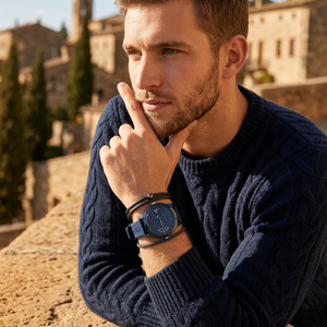 Elegant man wearing Tommy Hilfiger Denim 1791556 men's quartz battery watch with blue-tone case and innovative dual-time display