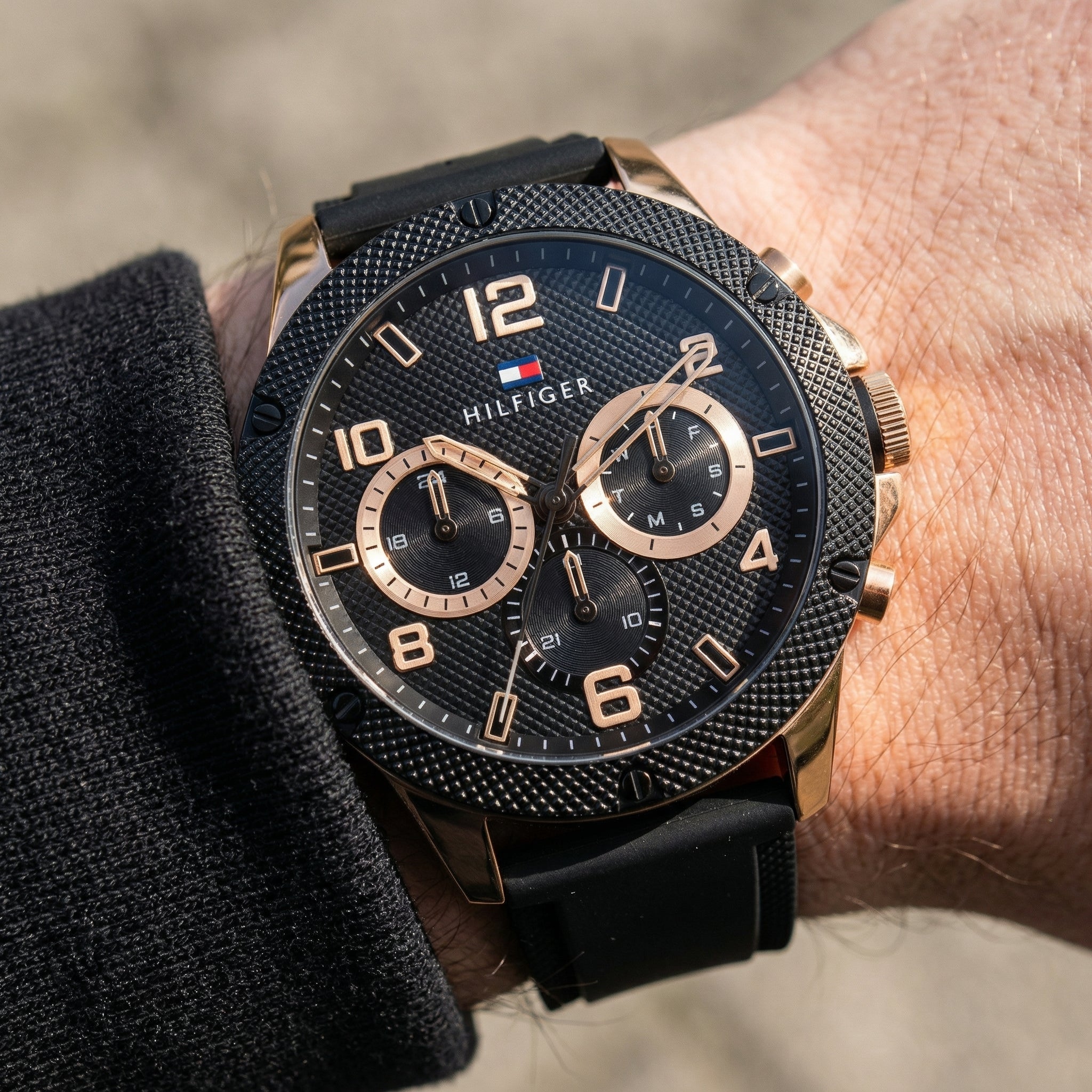 Close up shot of Tommy Hilfiger 1792028 on wrist showing black dial and rose gold sub-dial counters