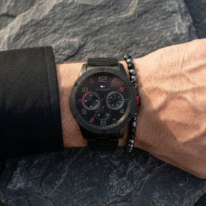 Close up shot of Tommy Hilfiger 1792030 on wrist showing black dial and red sub-dial accents