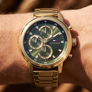 Close up shot of Tommy Hilfiger 1792216 on wrist showing the large gold case and multifunction dial