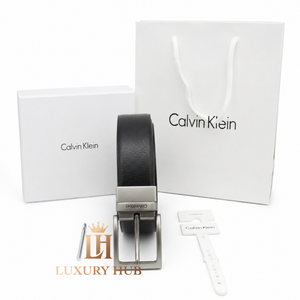 Ultra-realistic close-up of the Calvin Klein brushed metal buckle with precision-engraved brand logo