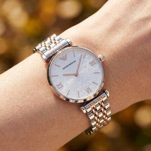 Close up shot of AR1987 highlighting the white dial with stunning crystal pave center and rose gold hands