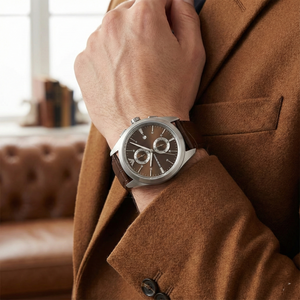 Lifestyle view of man wearing Emporio Armani AR11482 leather watch with brown suit