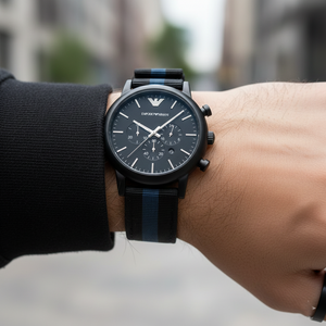 Lifestyle macro of Armani AR1948 watch showing nylon strap texture and shirt cuff