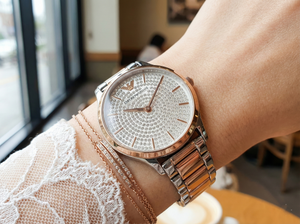 Close-up of Emporio Armani AR11537 crystal dial on woman's wrist with jewelry