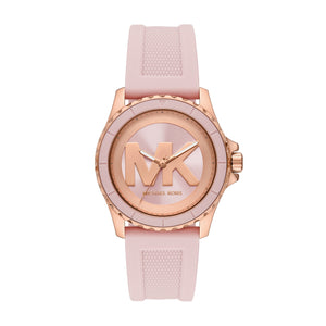 MK7536 Michael Kors analog watch with a light pink textured silicone strap, a rose gold-tone case, and a matching rose gold dial featuring a large 'MK' logo.