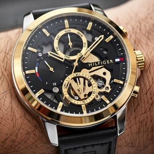Tommy Hilfiger Henry 1710474 men's watch with two-tone silver and gold case, skeleton dial, and black leather strap