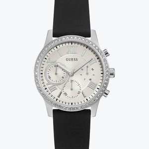 Guess Sunrise Multi-Function W1135L5 women's watch with cushion-shaped silver-tone case, dynamic bezel embellished with crystals and screw details, deep silver-white dial with luminous gold hands and indices, three distinct crowns on the side, and integrated flexible black silicone rubber strap main view