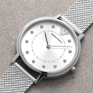 Silver Emporio Armani watch with a textured strap on a gray background
