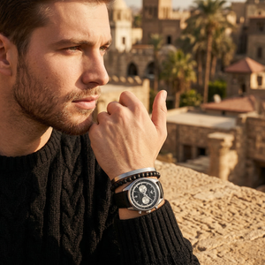 Elegant man wearing Emporio Armani Racer AR11635 men's quartz battery watch with silver-tone case and sporty leather strap