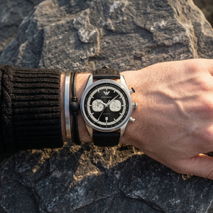 Close up of Emporio Armani Racer AR11635 men's quartz battery watch on wrist showing black chronograph dial and racing leather strap