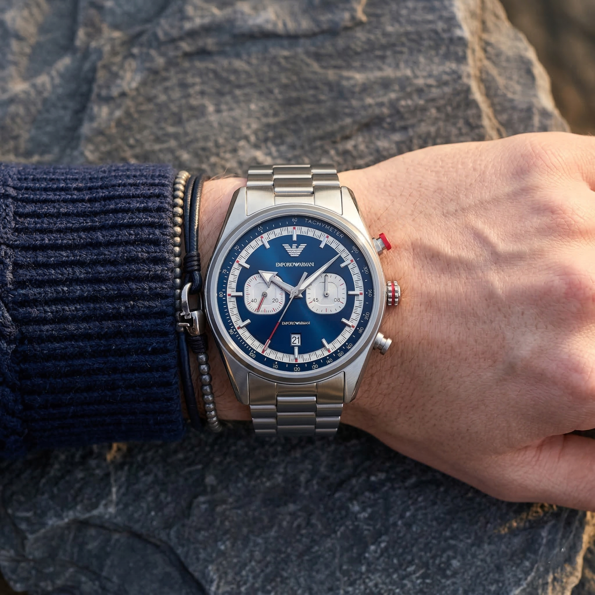 Close up of Emporio Armani Racer AR11676 men's quartz battery watch on wrist showing blue chronograph dial and silver metal bracelet