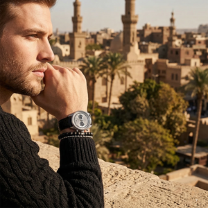 Elegant man wearing Emporio Armani Racer AR11677 men's quartz battery watch with silver-tone case and sporty leather strap