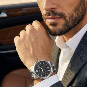 Lifestyle photo of Emporio Armani Dario AR11691 showing the bold silver watch on a man's wrist