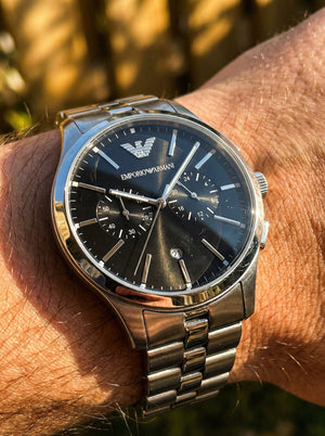 Close up shot of Emporio Armani Dario AR11691 on wrist showing black dial and silver sub-dials
