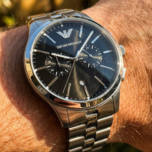 Close up shot of Emporio Armani Dario AR11691 on wrist showing black dial and silver sub-dials
