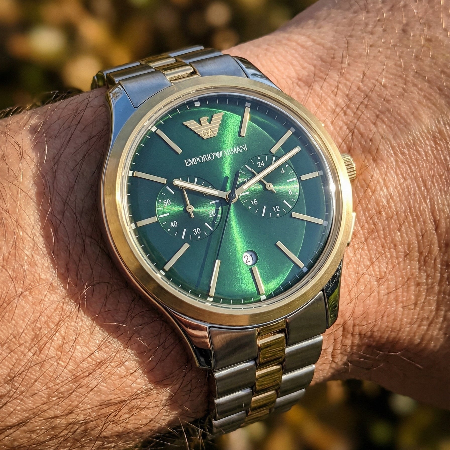 Close up shot of Emporio Armani Dario AR11692 on wrist showing green dial and chronograph sub-dials
