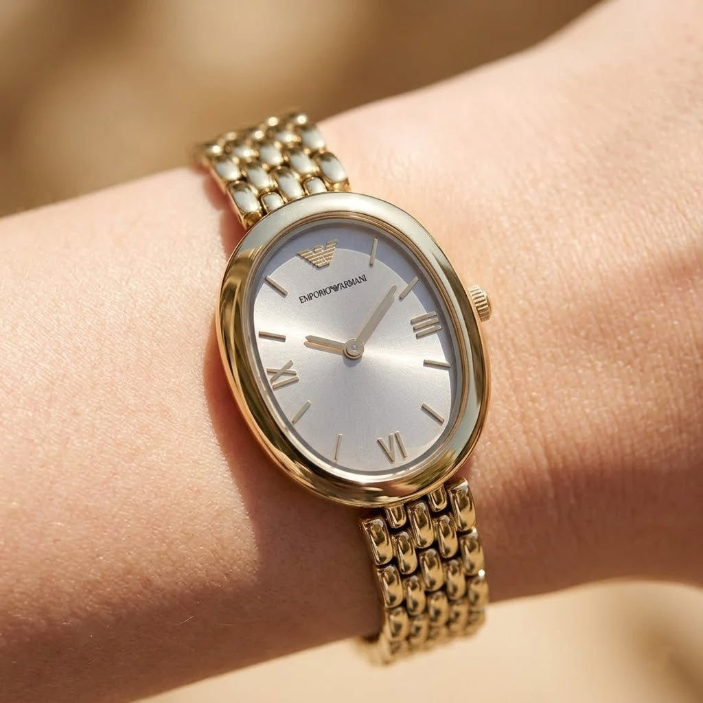 Close up shot of Emporio Armani AR11707 on wrist showing the delicate gold case and gray sunray dial