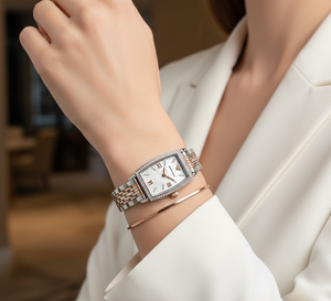 Elegant woman wearing Emporio Armani AR11519 rectangular two-tone watch with blazer