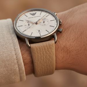 Extreme wrist macro of Armani AR11107 showing textured beige leather strap and gunmetal lugs