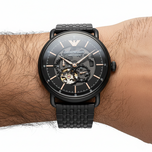 Close up of the AR60025 black dial showing the open-heart window and rose gold-tone hands