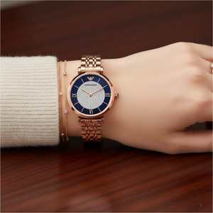Close-up of Armani AR11423 watch on wrist with stacked bracelets and sweater cuff