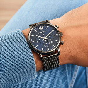 Extreme wrist macro of Armani AR1979 showing gunmetal mesh strap weave and blue dial
