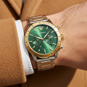 Extreme wrist macro of Armani AR11454 showing gold tachymeter bezel and green dial