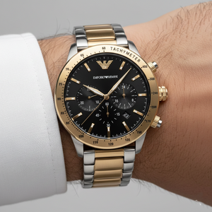 Extreme wrist macro of Armani AR11521 showing gold tachymeter bezel and black dial
