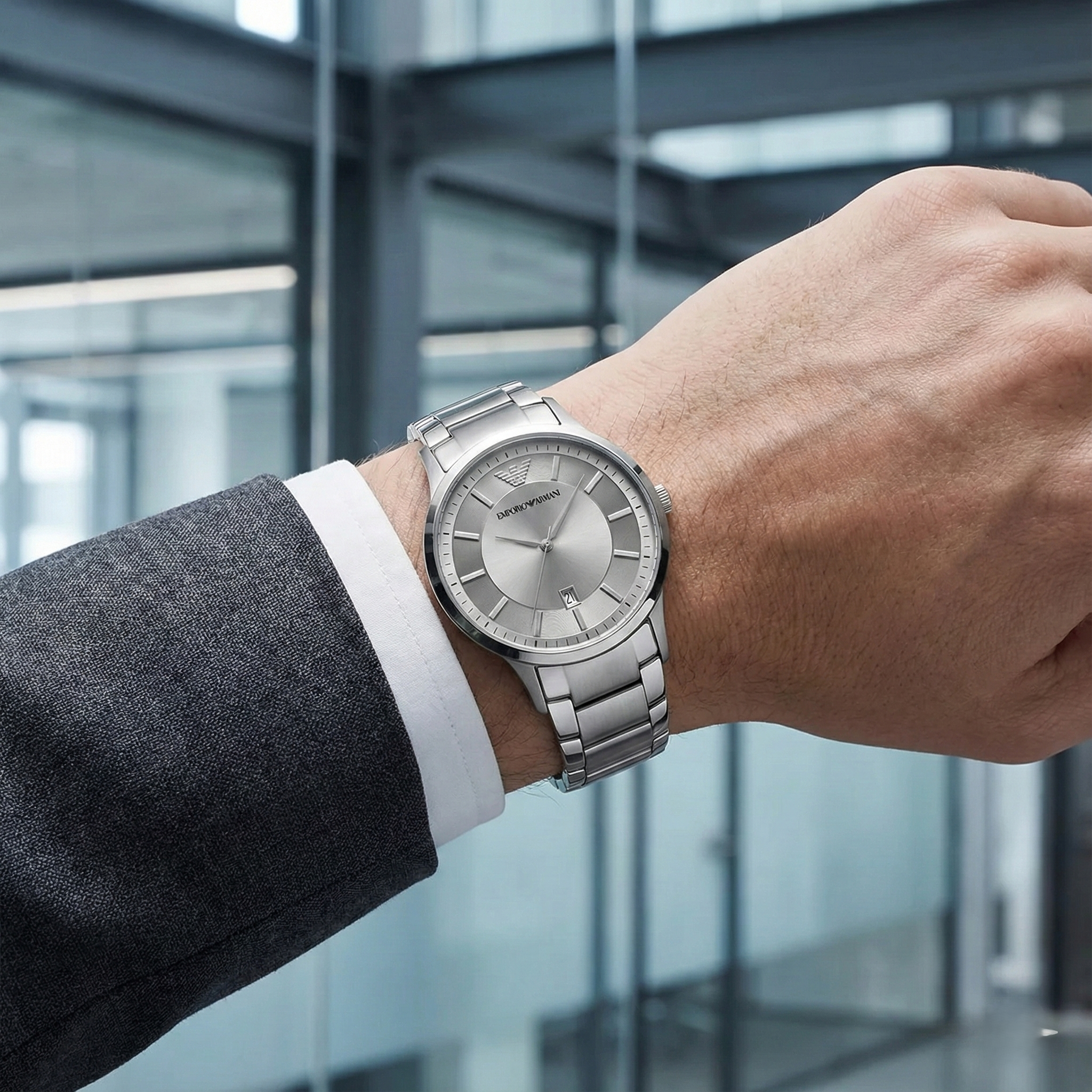 Corporate executive wearing Emporio Armani AR11189 silver slim watch with charcoal suit