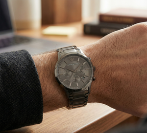 Close up of Armani AR2453 showing black sunray dial and black hands