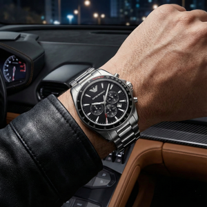 Man wearing Emporio Armani AR6098 silver steel watch with black tachymeter bezel