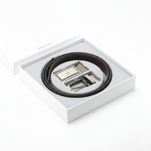 Luxury Calvin Klein men's 3-piece accessory gift set showcasing a black leather belt and two interchangeable buckles inside a premium branded window box