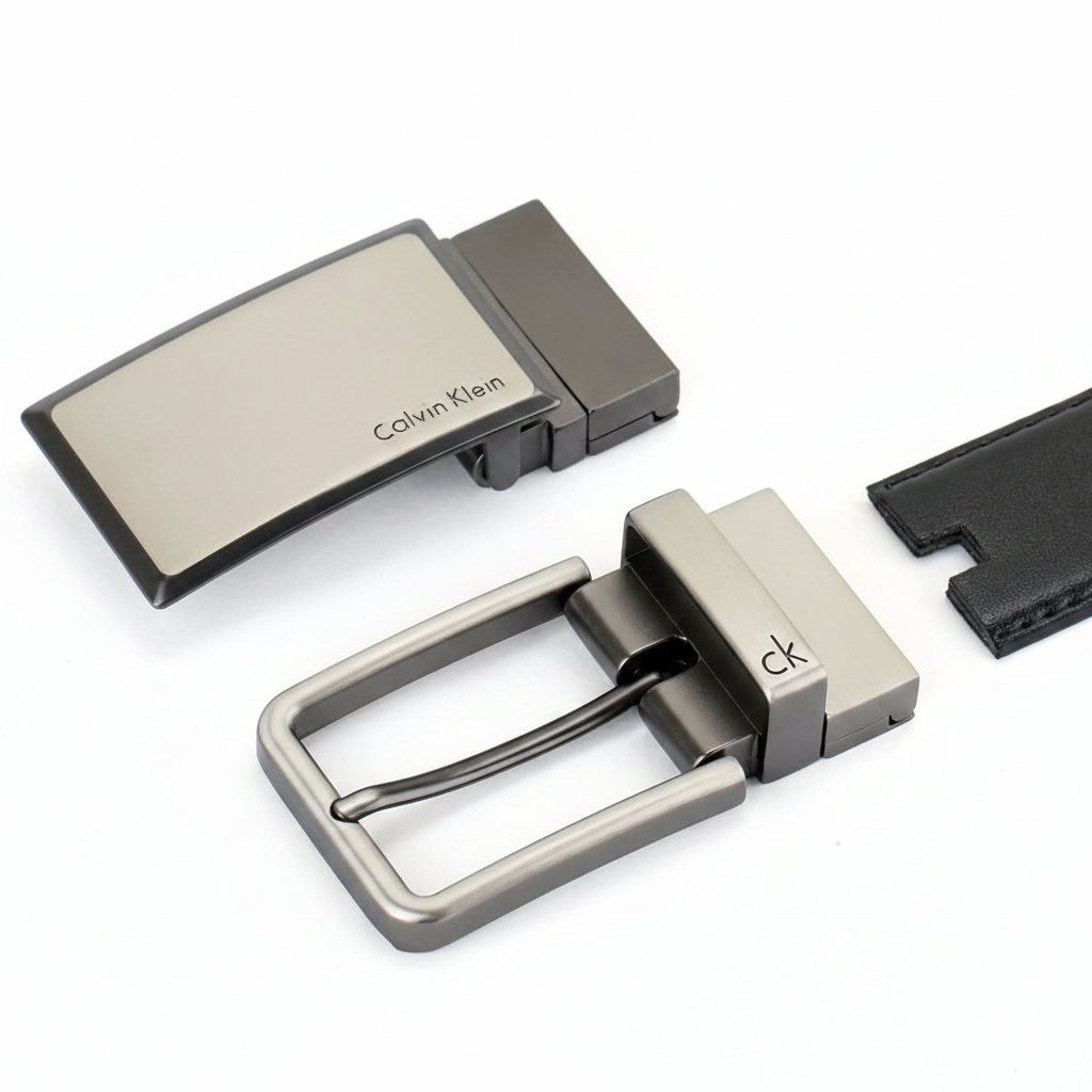 Close-up of the Calvin Klein reversible belt showing the black leather side with two interchangeable gunmetal buckles for versatile styling