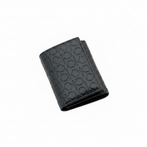 Straight-on front view of a closed Calvin Klein men's black leather wallet showcasing the all-over embossed CK logo pattern and front flap design