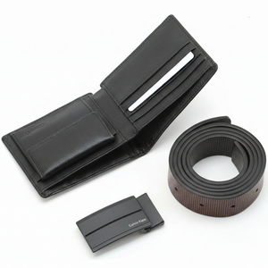 Open view of Calvin Klein black pebble leather wallet showing card slots and coin pocket, displayed with matching belt and matte black buckle