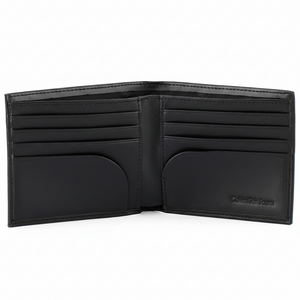 Interior view of a Calvin Klein black smooth leather wallet displaying multiple card slots and the embossed Calvin Klein Jeans logo