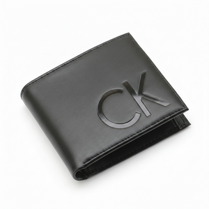 High-angle view of a slightly open Calvin Klein men's black smooth leather bifold wallet featuring a large debossed CK logo on the front