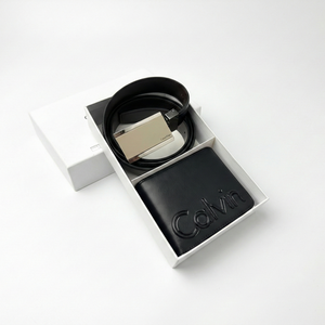 Flat lay of Calvin Klein gift set featuring reversible black brown belt and wallet