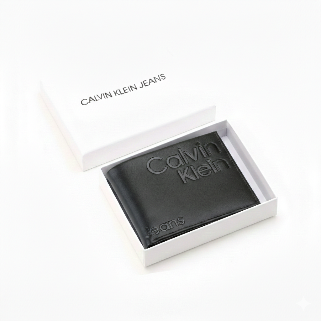 A closed Calvin Klein Jeans men's black genuine leather wallet featuring a large debossed logo, placed elegantly next to its matching closed white branded gift box