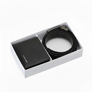 Calvin Klein Jeans men's accessory gift set featuring a black leather bifold wallet and a rolled reversible leather belt inside a premium white branded presentation box