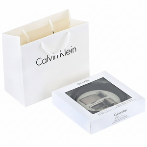 Premium Calvin Klein men's gift set featuring a double-face leather belt and two buckles, presented in a luxury white branded box with a matching shopping bag