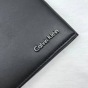Close up of Metal Calvin Klein Logo on Black Leather Wallet