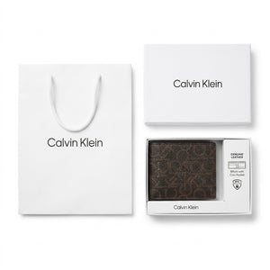 Full premium packaging presentation of the Calvin Klein mirror original smooth black leather bifold wallet alongside its white gift box and matching shopping bag