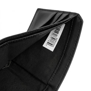 High-angle interior view of the opened Calvin Klein leather wallet currency compartment highlighting the original white tracking barcode label and fabric lining