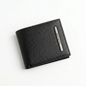 Live front view smartphone photograph of the Calvin Klein smooth black leather bifold wallet highlighting the round silver metal CK hardware logo corner accent