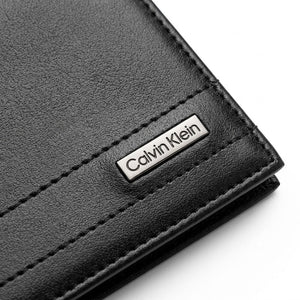 Black leather wallet with Calvin Klein logo on a white background