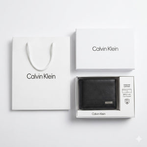 Professional angled studio photograph of the sleek Calvin Klein mirror original smooth black leather bifold wallet with silver logo plate